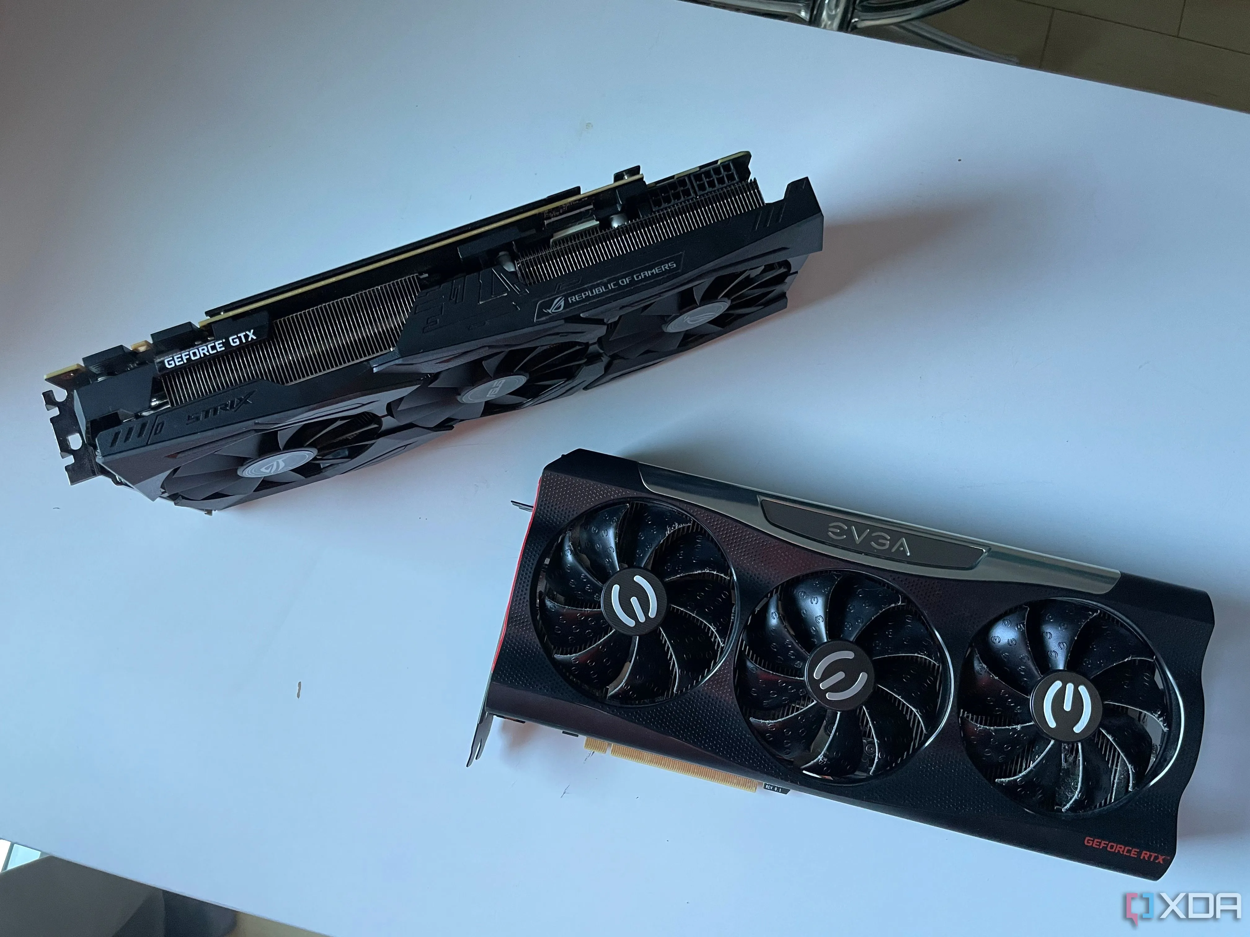 Hình ảnh so sánh hai card đồ họa ASUS STRIX GTX 1080 Ti và EVGA RTX 3080 đặt trên bàn, cho thấy sự thay đổi giữa các thế hệ GPU