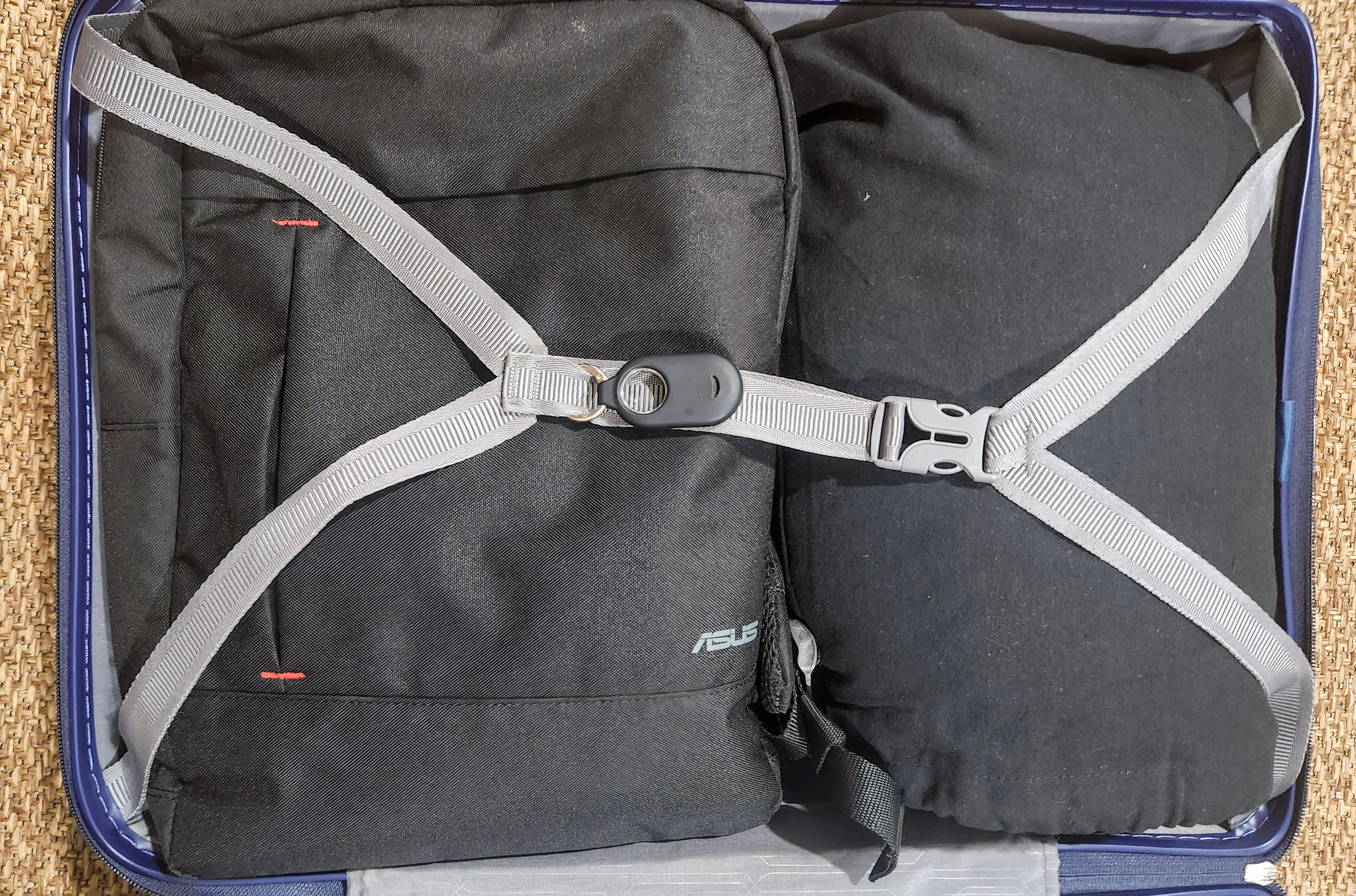 A tracker attached to a suitcase strap.