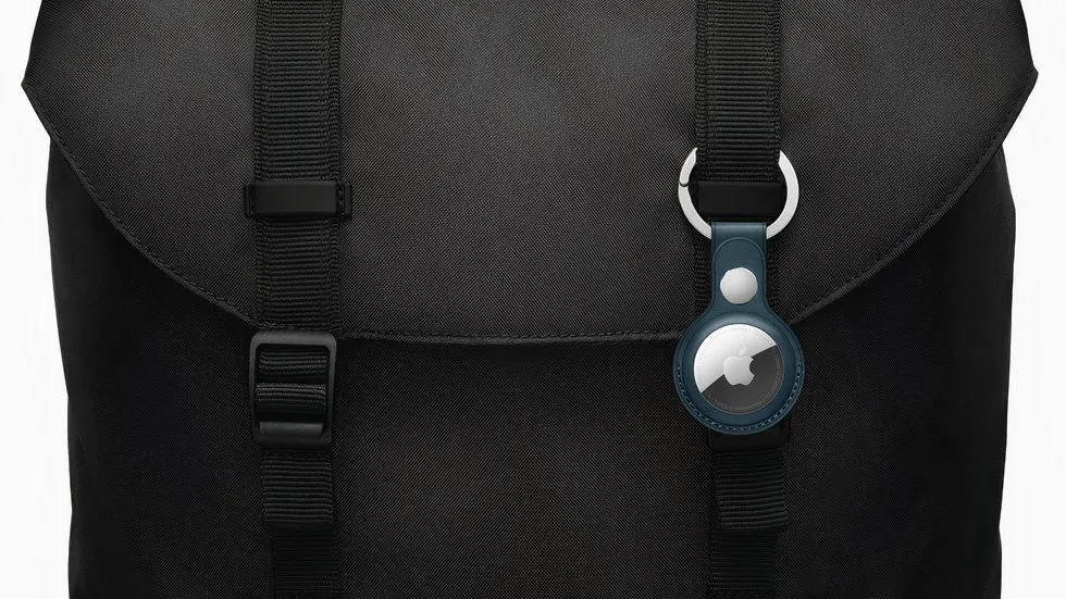 An Apple AirTag attached to a bag.