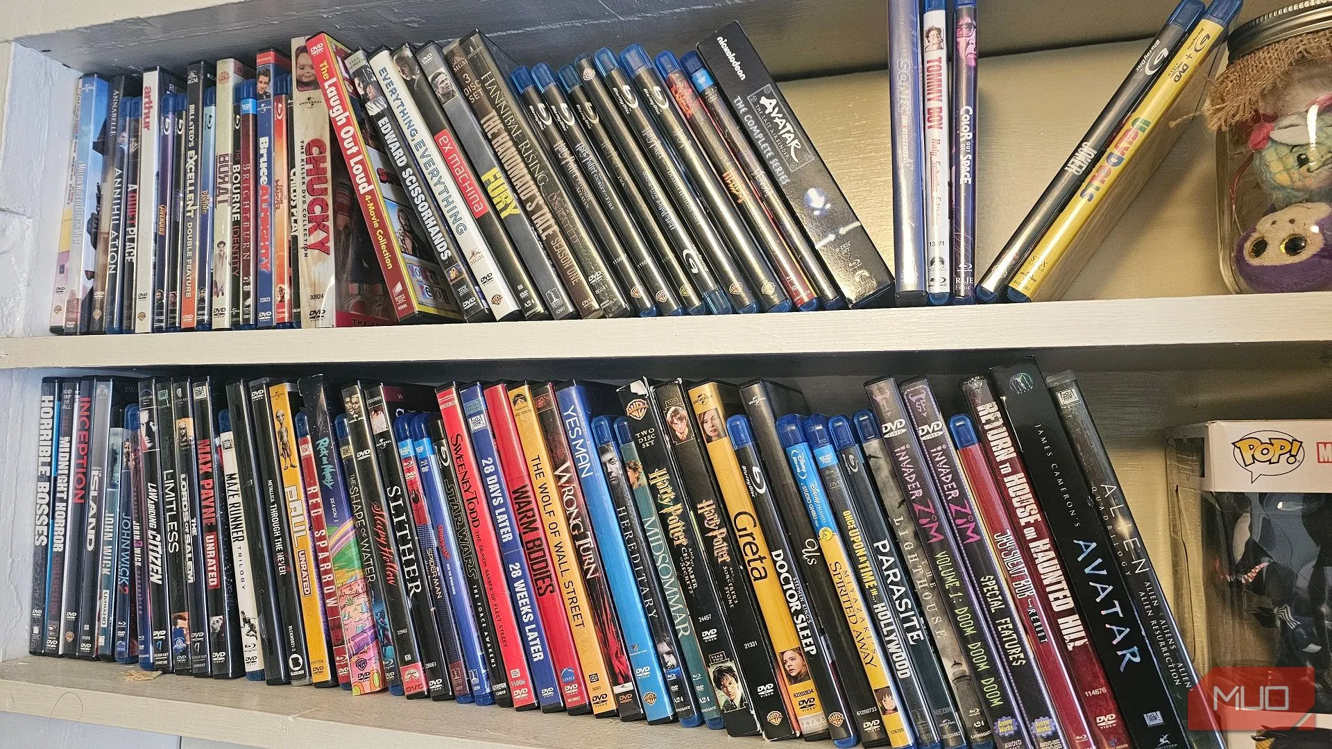 Hai kệ chứa đầy đĩa DVD và Blu-ray với nhiều bộ phim